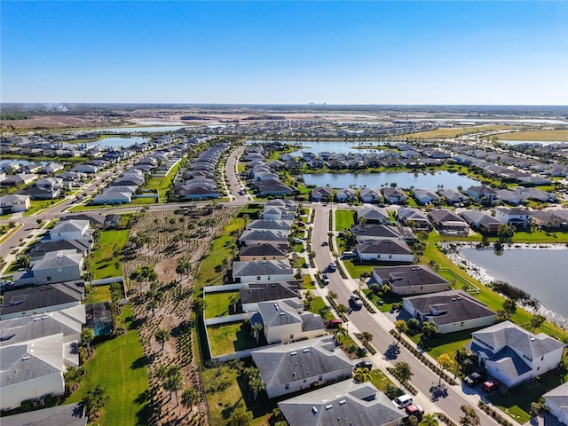 drone / aerial view with a residential view and a water view