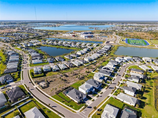 drone / aerial view featuring a residential view and a water view