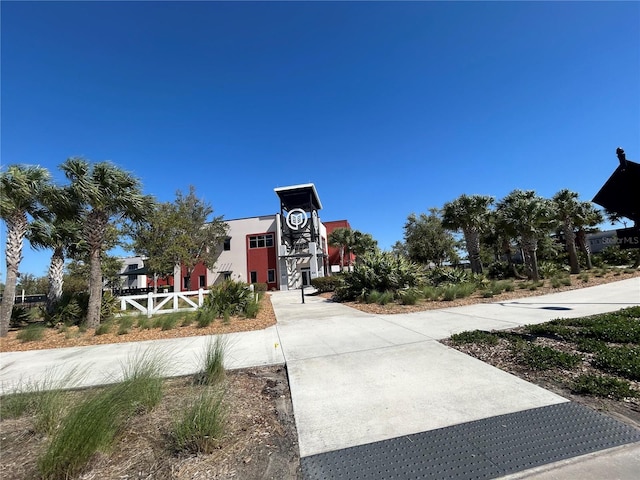 view of home's community featuring fence