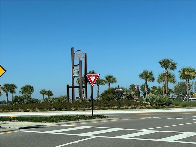 view of road with sidewalks, curbs, and traffic signs