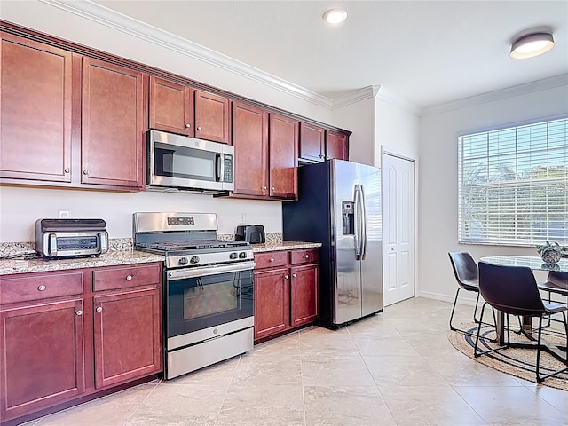 kitchen featuring a toaster, crown molding, baseboards, stainless steel appliances, and light stone counters