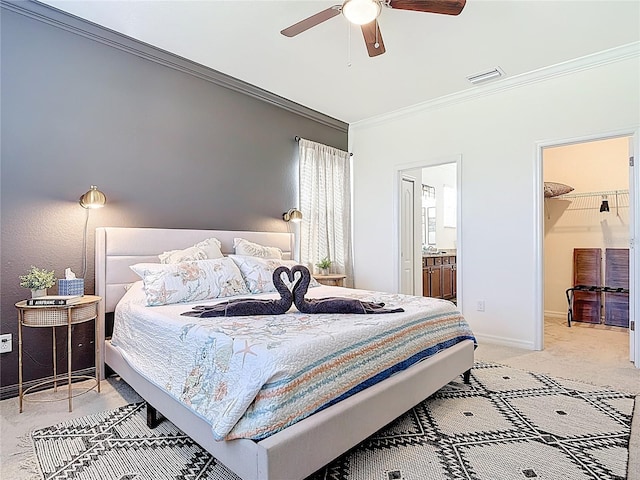 bedroom featuring connected bathroom, baseboards, light colored carpet, visible vents, and ornamental molding