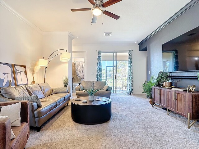 carpeted living room featuring a ceiling fan, ornamental molding, and visible vents