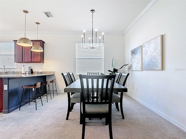 dining area with light carpet, baseboards, visible vents, ornamental molding, and an inviting chandelier