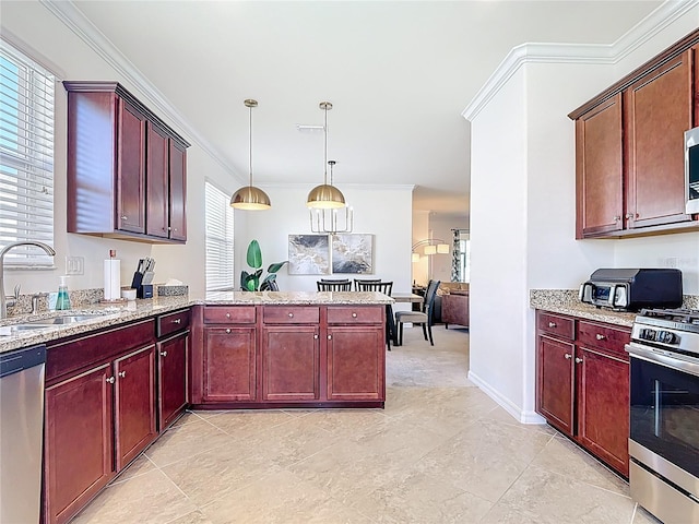 kitchen with reddish brown cabinets, a sink, stainless steel appliances, decorative light fixtures, and ornamental molding