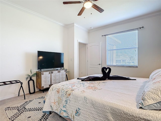 bedroom featuring a ceiling fan, carpet floors, ornamental molding, and baseboards