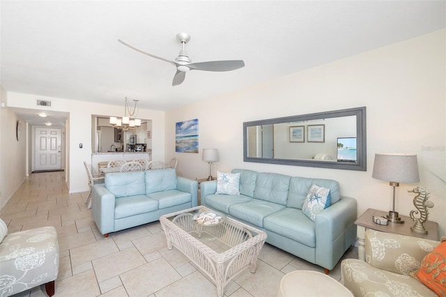 living room featuring visible vents and ceiling fan with notable chandelier