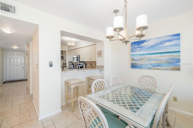 dining room featuring visible vents, baseboards, and an inviting chandelier