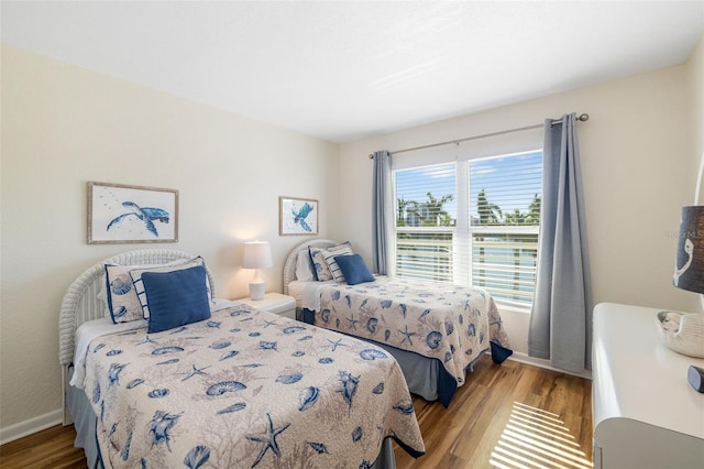 bedroom with baseboards and light wood-style flooring