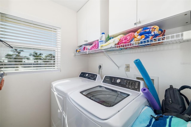 laundry room with cabinet space and washing machine and clothes dryer