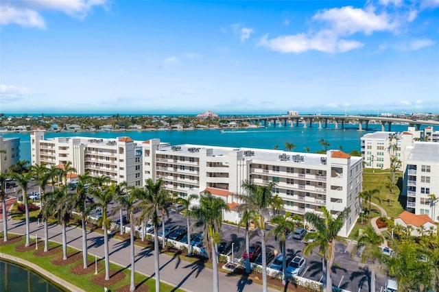 drone / aerial view with a city view and a water view