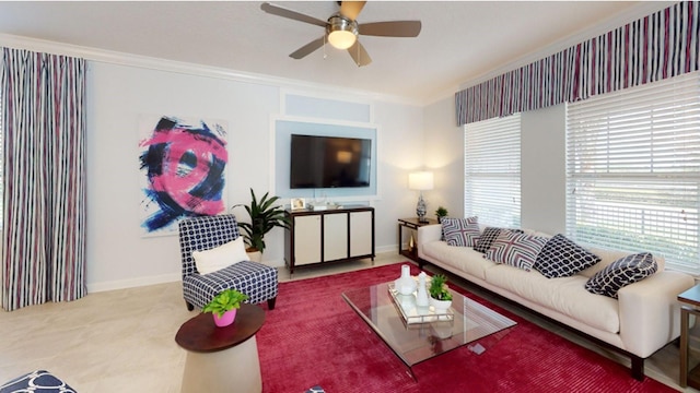 living room with baseboards, crown molding, and ceiling fan