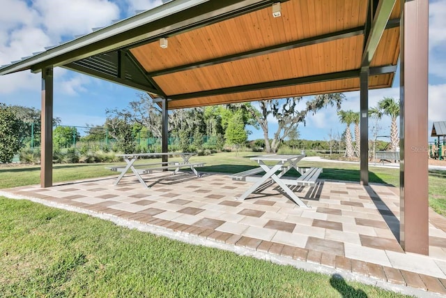 surrounding community featuring a patio area and a lawn