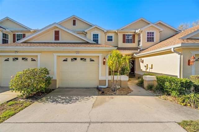 view of front facade with stucco siding, driveway, and an attached garage