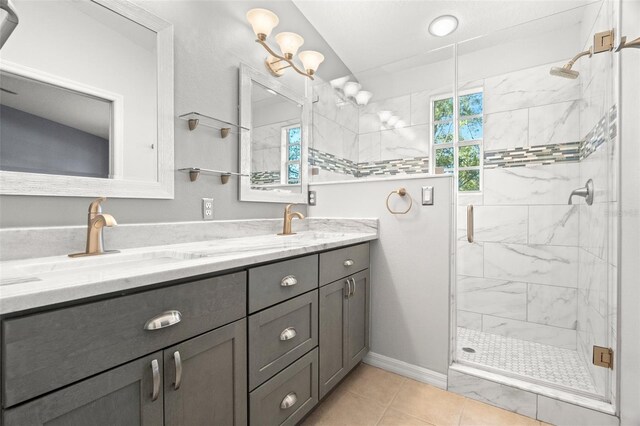 full bath featuring double vanity, a shower stall, and a sink