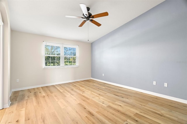 unfurnished room with ceiling fan, light wood-type flooring, and baseboards