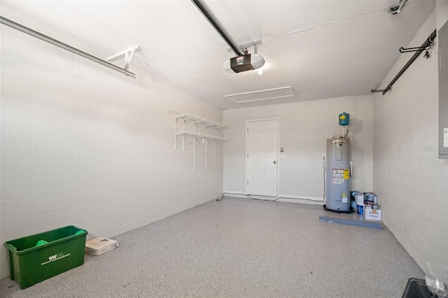 garage featuring concrete block wall, a garage door opener, and electric water heater