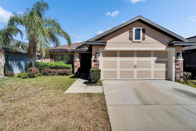 view of front of home featuring stone siding, a garage, driveway, and stucco siding