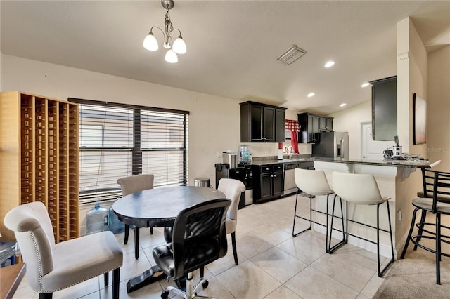 dining room featuring visible vents, a chandelier, vaulted ceiling, light tile patterned floors, and recessed lighting