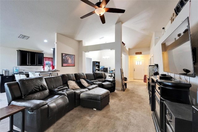 living room with visible vents, baseboards, lofted ceiling, ceiling fan with notable chandelier, and light colored carpet