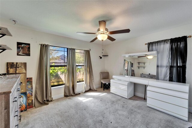 unfurnished office featuring baseboards, carpet, and a ceiling fan