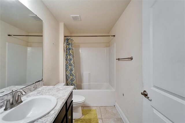 full bathroom with vanity, visible vents, shower / bath combination with curtain, tile patterned floors, and toilet