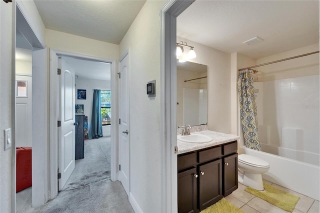 bathroom with tile patterned floors, toilet, shower / tub combo with curtain, a textured ceiling, and vanity