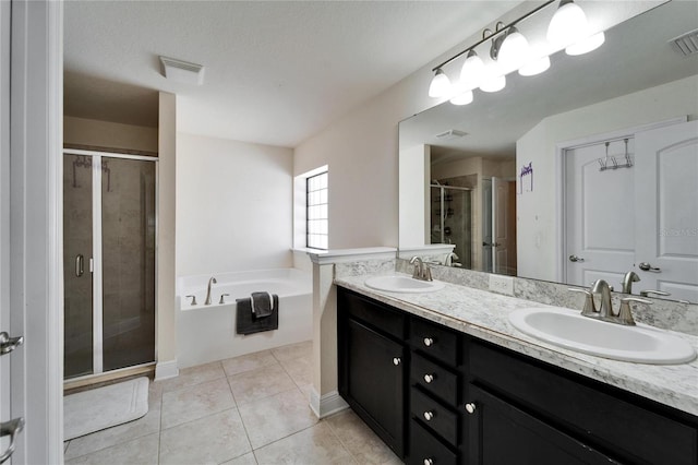 bathroom featuring a sink, a stall shower, double vanity, and tile patterned flooring