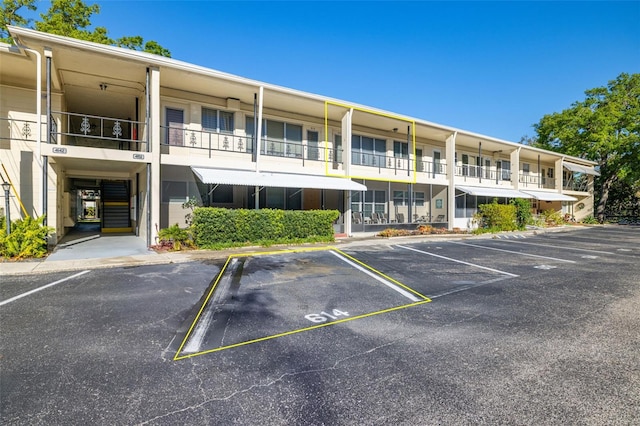 view of building exterior with uncovered parking