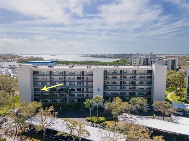 view of building exterior featuring a water view and a view of city