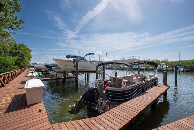 dock area with boat lift and a water view