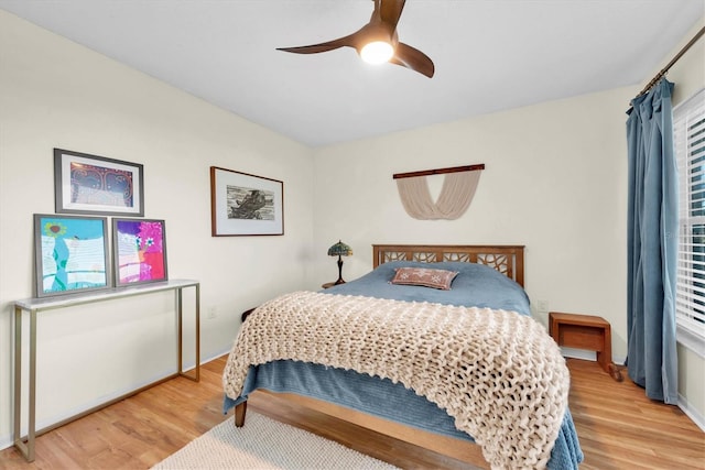 bedroom with light wood-style flooring and ceiling fan