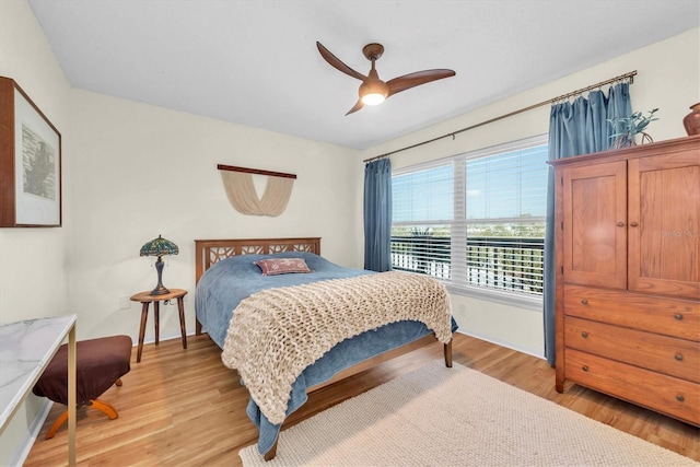 bedroom with light wood-style flooring and ceiling fan