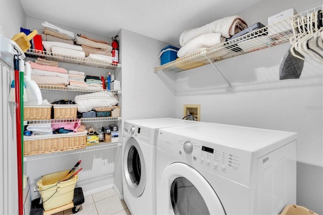 laundry area featuring laundry area, light tile patterned flooring, and separate washer and dryer