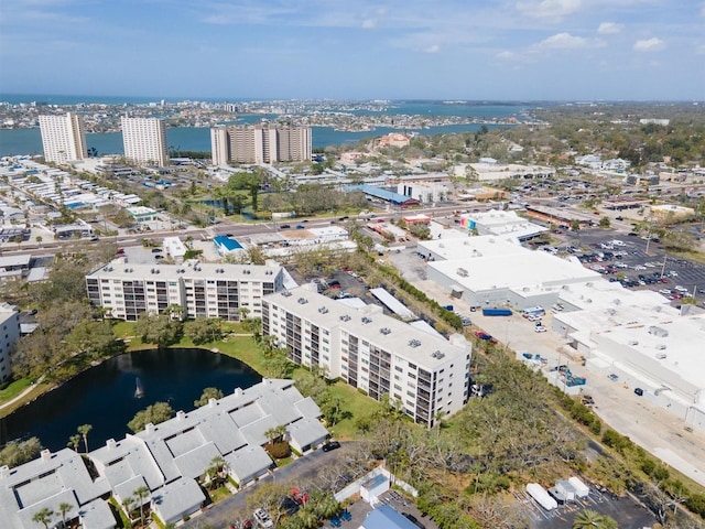 drone / aerial view featuring a city view and a water view