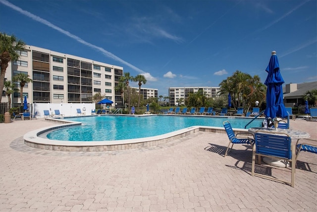 pool with fence and a patio area