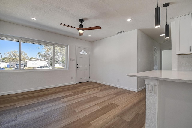 foyer entrance featuring visible vents, recessed lighting, baseboards, and light wood-style floors