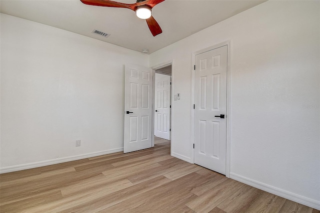 unfurnished bedroom with visible vents, baseboards, light wood-type flooring, and ceiling fan