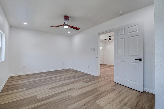 empty room with a ceiling fan, light wood-style flooring, recessed lighting, and baseboards