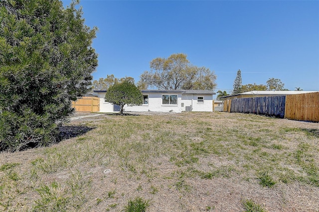 back of property featuring fence