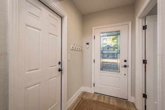 entryway with light wood-style floors and baseboards