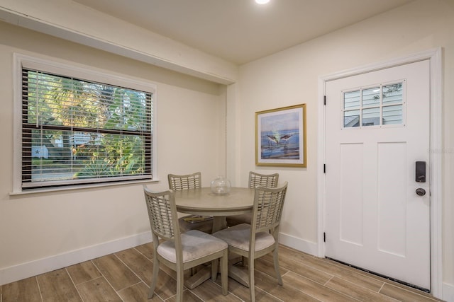 dining area with baseboards and wood finish floors