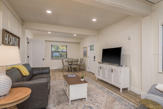 living room with recessed lighting, baseboards, beam ceiling, and wood finished floors