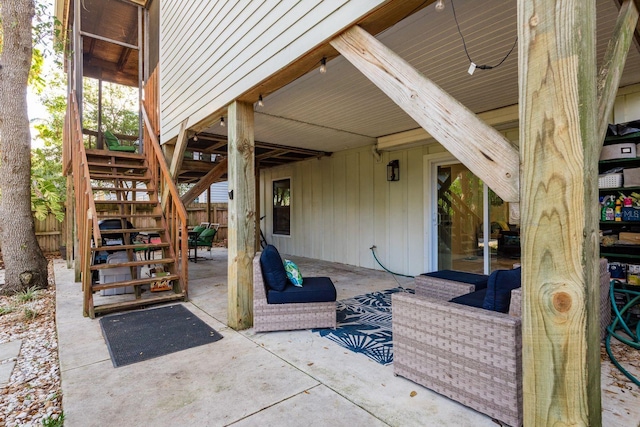 view of patio featuring stairs and fence