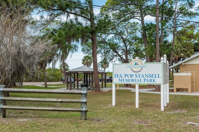 surrounding community with a gazebo and a yard