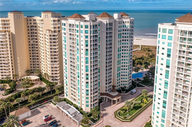 view of building exterior with a city view and a water view