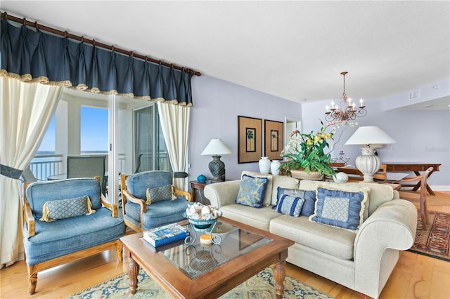 living room with an inviting chandelier and wood finished floors