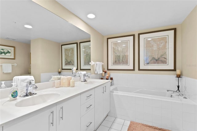 full bathroom featuring tile patterned flooring, double vanity, a bath, and a sink