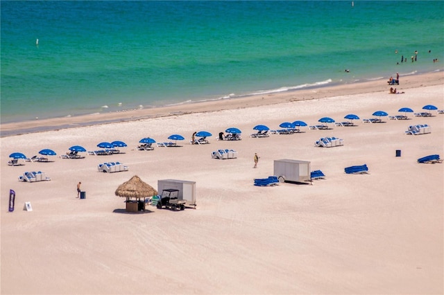 birds eye view of property featuring a water view and a view of the beach