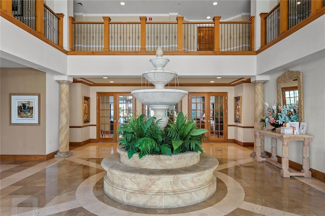 entrance foyer with french doors, baseboards, and decorative columns